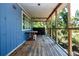 Wide, screened porch with wooden floor and ceiling offers peaceful spot to relax and enjoy the outdoors at 1616 Lightfoot Rd, Wimauma, FL 33598