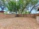 Large, leafy backyard with a wooden fence at 1700 25Th N St, St Petersburg, FL 33713