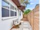 Back exterior of the home, featuring a wooden bench and walkway at 1700 25Th N St, St Petersburg, FL 33713