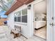 Rear exterior view of a home featuring an entrance, seating area, and outdoor grill at 1700 25Th N St, St Petersburg, FL 33713