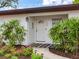 Inviting front entryway with a decorative door, charming plants and landscape lighting at 1700 25Th N St, St Petersburg, FL 33713