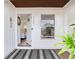 Charming entryway with a decorative rug, and an open view into the living room at 1700 25Th N St, St Petersburg, FL 33713
