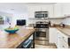 Bright kitchen showcasing stainless steel appliances and center island. Open to the living area at 1700 25Th N St, St Petersburg, FL 33713