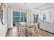Dining area with modern chandelier and sliding glass doors leading to a screened-in pool at 17085 Moonflower Dr, Venice, FL 34293