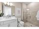 Bathroom features a walk-in shower, a white vanity, and views into a bedroom at 17094 Moonflower Dr, Venice, FL 34293