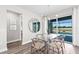 Bright dining space with a glass table, view of the pool, and access to outdoor entertaining at 17094 Moonflower Dr, Venice, FL 34293