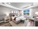 Elegant bedroom with wood-look floors, and a stylish seating area for relaxation and comfort at 17094 Moonflower Dr, Venice, FL 34293