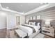 Serene bedroom featuring a padded headboard, soft lighting, and a calming neutral color palette at 17094 Moonflower Dr, Venice, FL 34293