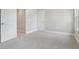 Spacious bedroom with neutral carpet and featuring two doors, offering plenty of natural light at 1913 W Pine St, Tampa, FL 33607
