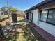 Private backyard access near community pool featuring a fence, greenery, and sunny spot for outdoor activities at 2055 Sunset Point Rd # 3804, Clearwater, FL 33765