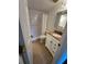 Bathroom boasts granite countertop, tiled floor, and walk-in shower with curtain at 2055 Sunset Point Rd # 3804, Clearwater, FL 33765