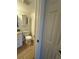 A cozy bathroom features a toilet, mirrored cabinet, and neutral tile flooring at 2055 Sunset Point Rd # 3804, Clearwater, FL 33765