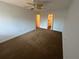 Carpeted bedroom with ceiling fan, leading to bathroom and walk-in closet at 2055 Sunset Point Rd # 3804, Clearwater, FL 33765