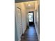 Hallway featuring wood floors, a bright light fixture, and an exterior door at 2055 Sunset Point Rd # 3804, Clearwater, FL 33765