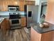 Kitchen with stainless steel appliances, wood cabinets, and granite countertops at 2055 Sunset Point Rd # 3804, Clearwater, FL 33765