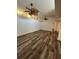 Bright living room featuring wood flooring and two ceiling fans at 2055 Sunset Point Rd # 3804, Clearwater, FL 33765