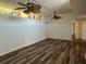 Spacious living room with modern wood flooring, bright natural light, and ceiling fans for added comfort at 2055 Sunset Point Rd # 3804, Clearwater, FL 33765