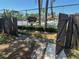 Community pool entrance showing a wooden gate and walkway, leading to the fenced-in pool area at 2055 Sunset Point Rd # 3804, Clearwater, FL 33765