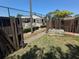 Community pool access through a wooden gate, offering a glimpse of lounge chairs and fenced-in area at 2055 Sunset Point Rd # 3804, Clearwater, FL 33765
