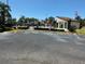Gated Community Pool surrounded by lush landscaping and various seating options at 2055 Sunset Point Rd # 3804, Clearwater, FL 33765