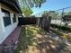Private side yard with a wooden fence, brick walkway, and potential for outdoor relaxation or gardening at 2055 Sunset Point Rd # 3804, Clearwater, FL 33765