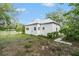 Backyard showcasing a quaint view framed by mature trees and a lush green lawn at 20653 Old Trilby Rd, Dade City, FL 33523