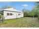 Backyard featuring mature trees, metal roof and siding, offering a peaceful retreat at 20653 Old Trilby Rd, Dade City, FL 33523