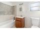 Functional bathroom featuring tiled tub, vanity, and essential fixtures at 20653 Old Trilby Rd, Dade City, FL 33523