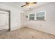This bedroom features carpet flooring, natural lighting, and a ceiling fan at 20653 Old Trilby Rd, Dade City, FL 33523