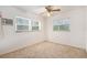 This bedroom features carpet flooring, natural lighting, and a ceiling fan at 20653 Old Trilby Rd, Dade City, FL 33523