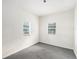 A simple yet functional bedroom with dual windows provides ample sunlight at 20653 Old Trilby Rd, Dade City, FL 33523