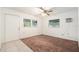 Bedroom featuring tile and carpet flooring, natural light and an access door at 20653 Old Trilby Rd, Dade City, FL 33523