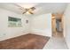 Bright bedroom featuring tile and carpet flooring with a ceiling fan at 20653 Old Trilby Rd, Dade City, FL 33523
