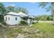Charming home featuring a covered porch and lush green lawn at 20653 Old Trilby Rd, Dade City, FL 33523