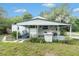 Charming home with inviting covered porch and well-kept front yard at 20653 Old Trilby Rd, Dade City, FL 33523