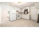 A kitchen featuring tile flooring, all-white appliances, and wooden cabinets at 20653 Old Trilby Rd, Dade City, FL 33523