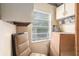 A small storage room featuring a window, carpeted chair, and shelving at 20653 Old Trilby Rd, Dade City, FL 33523