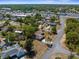 Aerial view of a home in a well-connected residential area with a mix of housing and businesses at 2072 Maguire Ave, Spring Hill, FL 34608