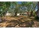 Spacious backyard featuring mature trees, lush greenery, shed and a well-maintained fence, offering privacy at 2072 Maguire Ave, Spring Hill, FL 34608