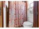 Close-up of the pink and white patterned shower curtain in the bathroom at 2072 Maguire Ave, Spring Hill, FL 34608