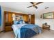 Bedroom with built-in headboard storage, side tables, and calming blue bedding at 2072 Maguire Ave, Spring Hill, FL 34608