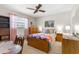 Bedroom with a colorful quilt, wood furniture, and bright sunlight at 2072 Maguire Ave, Spring Hill, FL 34608