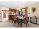 Dining room with a wooden table, six chairs, chandelier and view of the kitchen at 2072 Maguire Ave, Spring Hill, FL 34608