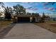 Home exterior with a paved driveway and stone accents, captured during the twilight hour at 2072 Maguire Ave, Spring Hill, FL 34608
