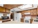 Efficient kitchen with white appliances, wood cabinets and skylight at 2072 Maguire Ave, Spring Hill, FL 34608