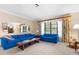 Bright living room with floral curtains, mirror accents and comfortable seating, perfect for relaxation at 2072 Maguire Ave, Spring Hill, FL 34608