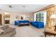 Bright and spacious living room featuring large windows, plush sofas, and neutral carpeting at 2072 Maguire Ave, Spring Hill, FL 34608