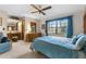 Comfortable bedroom with a large window, light blue comforter, and ensuite bathroom at 2072 Maguire Ave, Spring Hill, FL 34608