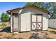 Exterior of a weathered outbuilding with double doors in the backyard at 2072 Maguire Ave, Spring Hill, FL 34608