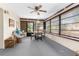 Enclosed sunroom features many windows and a ceiling fan at 2072 Maguire Ave, Spring Hill, FL 34608
